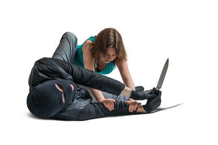 Young woman is fighting with armed mugger. Isolated on white background.