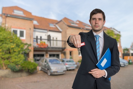 Realtor is selling house and passing keys.の写真素材