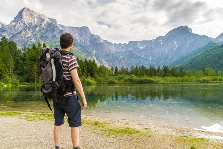 Hiking tourist from behind and lake near Alps in Almsee in Austria.の写真素材