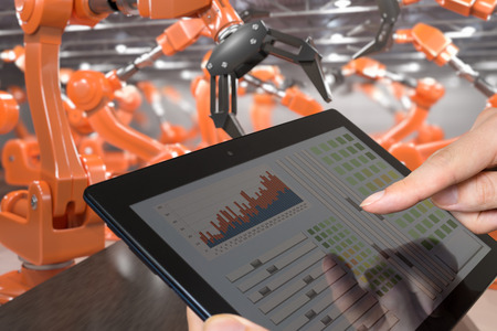 Man is controlling robotic arms with tablet. Automation and Industry 4.0 concept.