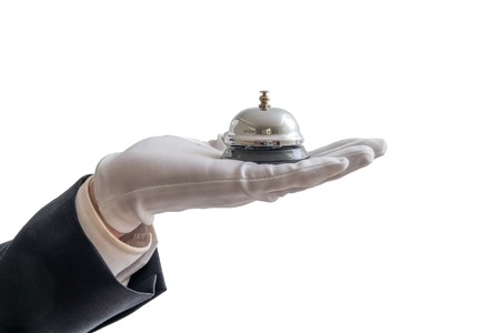 Hand in white glove is holding service bell. Isolated on white background.