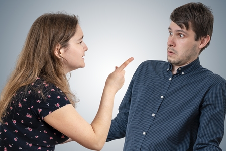 Jealousy hysterical wife is shouting and blaming her husband.の写真素材