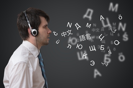 Young man with headphones is speaking in different foreign languages.