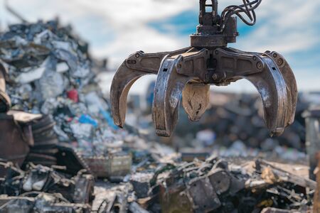 Close-up view on mechanical arm claw of crane at landfill.の写真素材