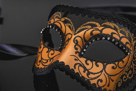 Traditional venetian carnival mask on black background.の写真素材