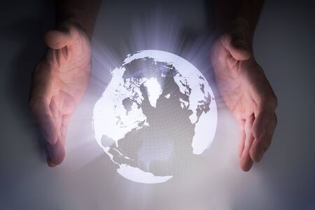 Holographic projection of Earth near mans hands.