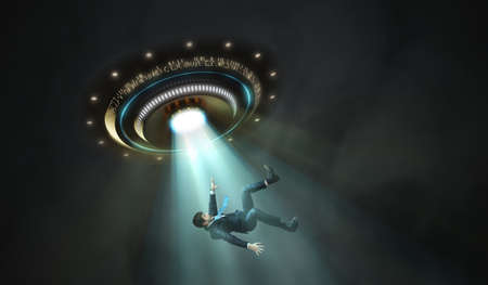 Alien abduction concept. Young man is abducted by UFO.の写真素材