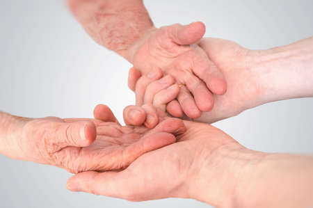 Senior or eldery assistance concept. Young man holds hands of senior woman.