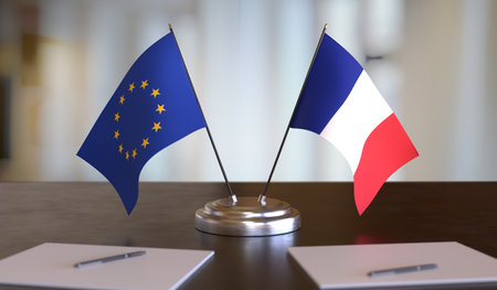 French and EU flags on table. Negotiations between the European Union and France. 3D rendered...