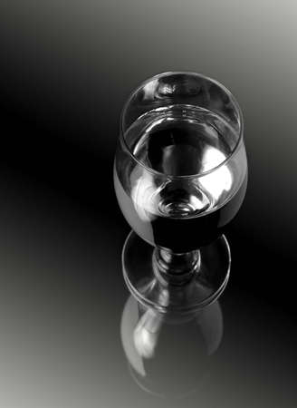 Glass of wine over mirrorの写真素材