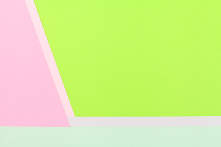 Color papers geometry flat composition background with green and rose tones