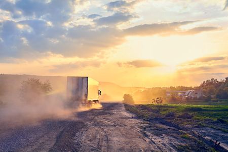 road transportation. Big car and bad road evening landscapeの写真素材