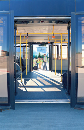 Airport bus with opened doors on the runwayの写真素材