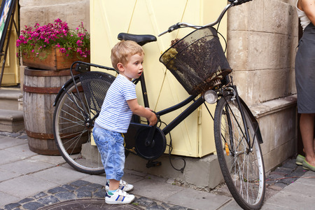 Boy walking on the old city streetの写真素材