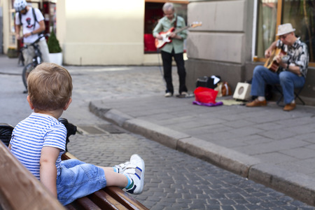 Boy listening street music in the city centreの写真素材