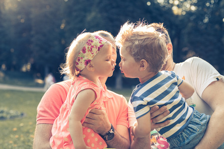 Young sweet childrens kissing in the parkの写真素材