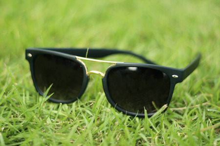 sunglasses on grass backgroundの写真素材
