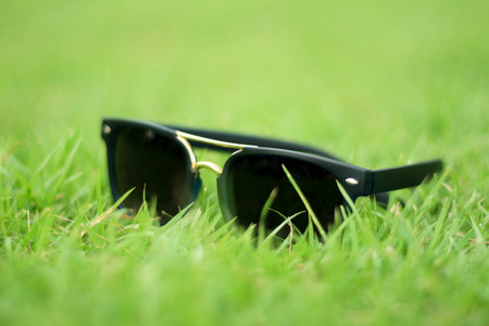 sunglasses on grass backgroundの写真素材