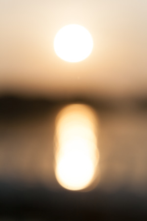 Abstract blurry sunset and shade on the lake backgroundの写真素材