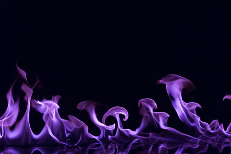 Purple flames isolated on black backgroundの写真素材