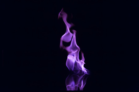 Purple flames isolated on black backgroundの写真素材