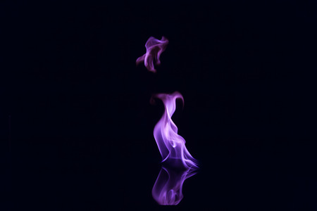 Purple flames isolated on black backgroundの写真素材