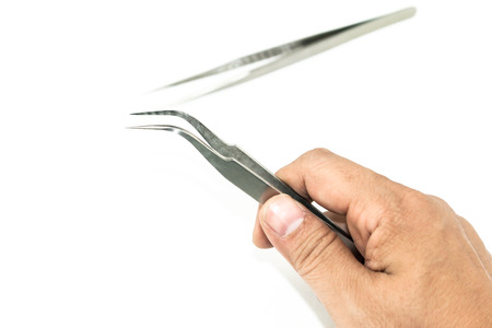 hand holding metal tweezers isolate on white background