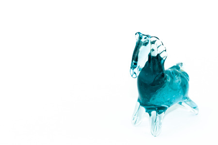 Horse blown glass translucent blue on a white backgroundの写真素材