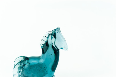 Horse blown glass translucent blue on a white backgroundの写真素材