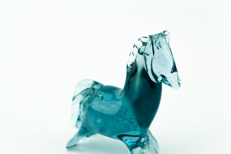 Horse blown glass translucent blue on a white backgroundの写真素材