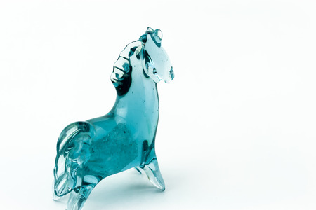Horse blown glass translucent blue on a white backgroundの写真素材