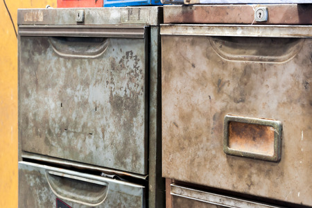 Old rusty metal drawer cabinet with instrument toolboxの写真素材