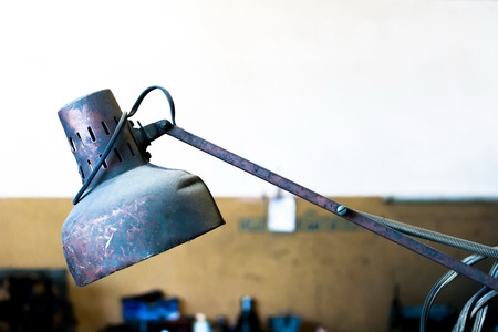 Red old metal lamp with rusty and dusty in factoryの写真素材