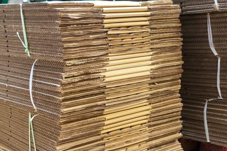Stacked brown corrugated cardboard boxes flattened boxes
