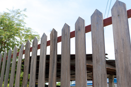Real brown Wooden fence with blue sky backgroundの写真素材