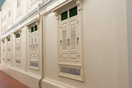 Thailand ancient windows painted white with metal hook bolts