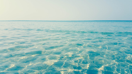 shallow water wave and clearly blue sky backgroundの写真素材