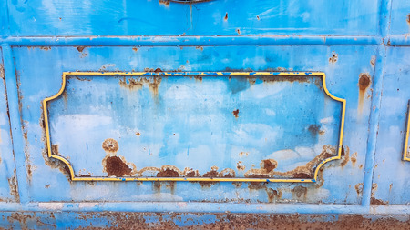 Abstract iron wheel with rush metal door in abadon and dirty placeの写真素材