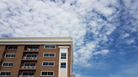 modern residence building with white cloud in blue sky background