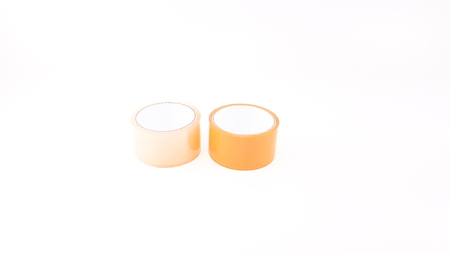 Thick transparent plastic tape and brown plastic tape in white big core isolatedの写真素材