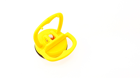 vacuum sucker with aluminium core in yellow plastic color and black rubber isolatedの写真素材