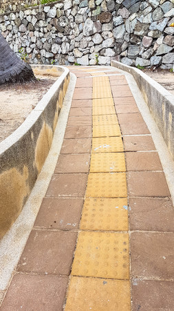 slope up path of brick walk way in garden and decorate with stone wallの写真素材