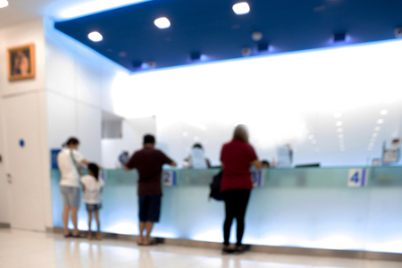 Blurry of customer who is waiting for service on blue service counter, Customers waiting for service.の写真素材