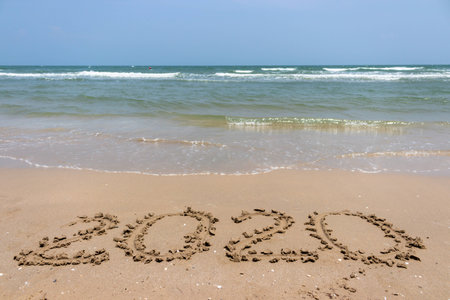 Number of year on the sand beach with sea wave