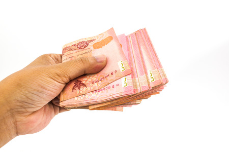 Thailand banknotes in the hand of man isolated on white background