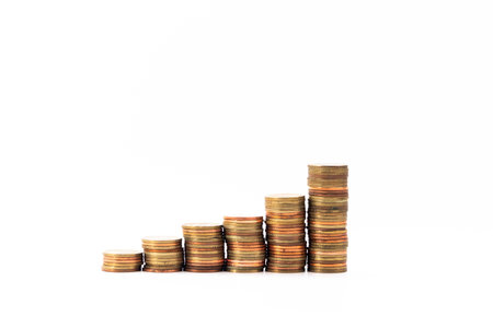 Copper and gold coins stacked on a white background isolated