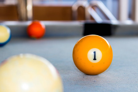 Billiard balls on the snooker table with gray felt floor.