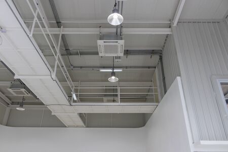The ceiling of studio building has decorated with lamps and tubesの写真素材