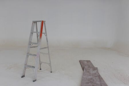 Old metal ladder in the room that are decorating and construction.の写真素材