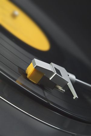 Tilted close up of headshell and stylus on a turntable
